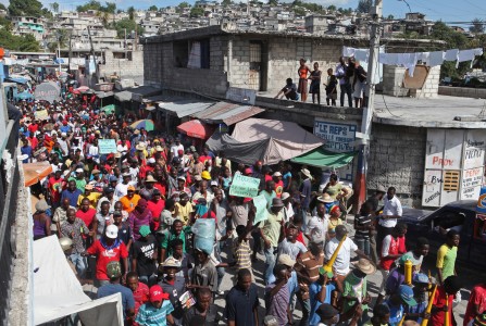 Demonstrators march through the streets during an anti-government protest in Port-au-Prince